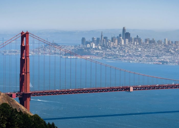 Aerial view of Golden Gate Bridge; the San Francisco skyline visible in the background; California