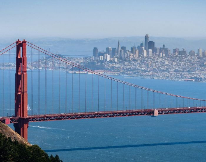 Aerial view of Golden Gate Bridge; the San Francisco skyline visible in the background; California